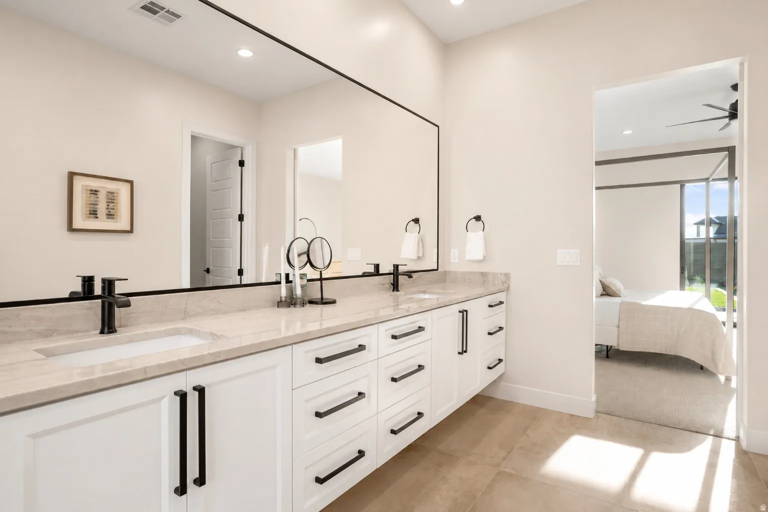 Double vanity featuring light-toned countertops and integrated sinks