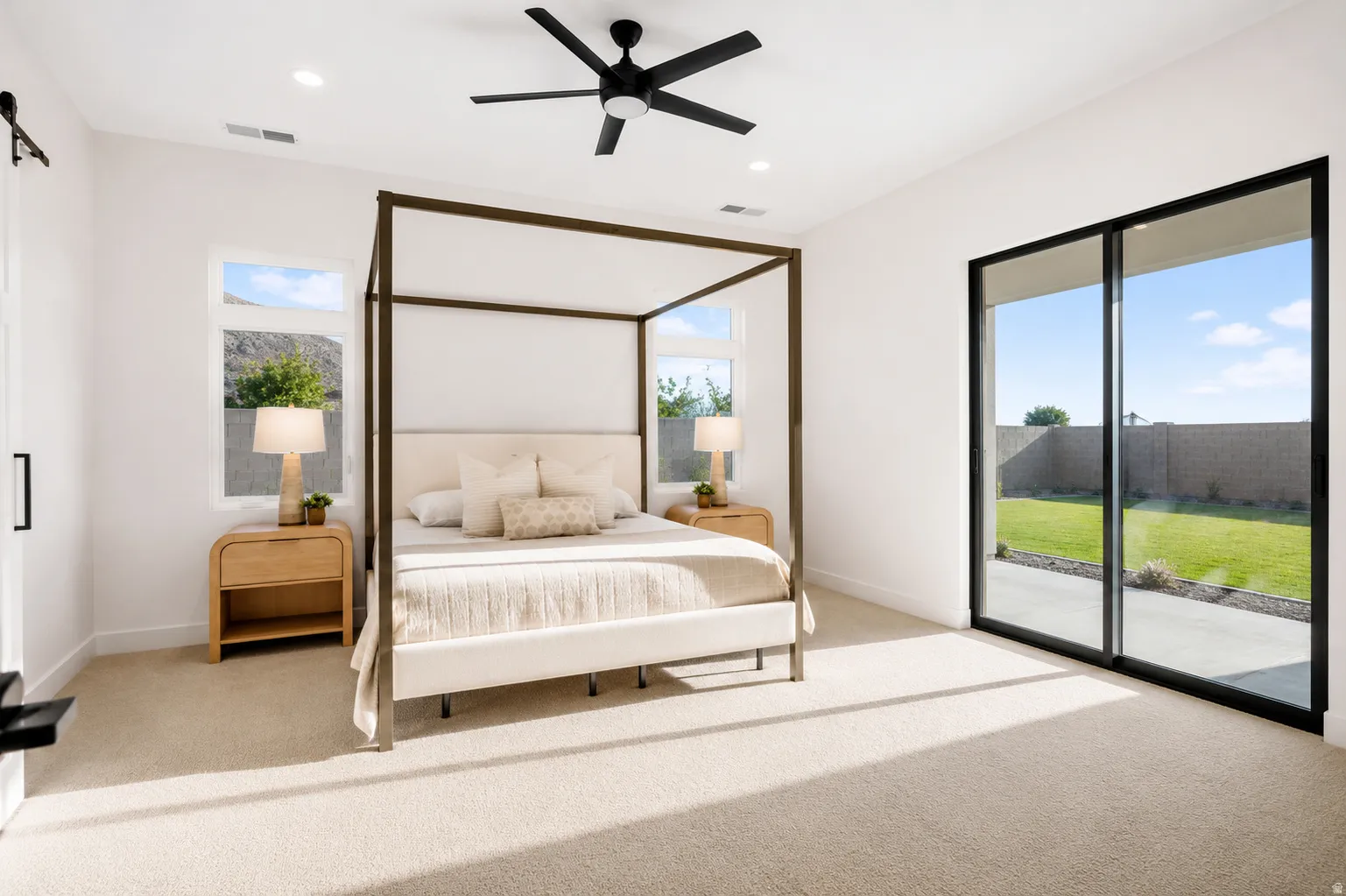 Spacious room featuring broad sliding glass doors opening to a concrete patio and lawn