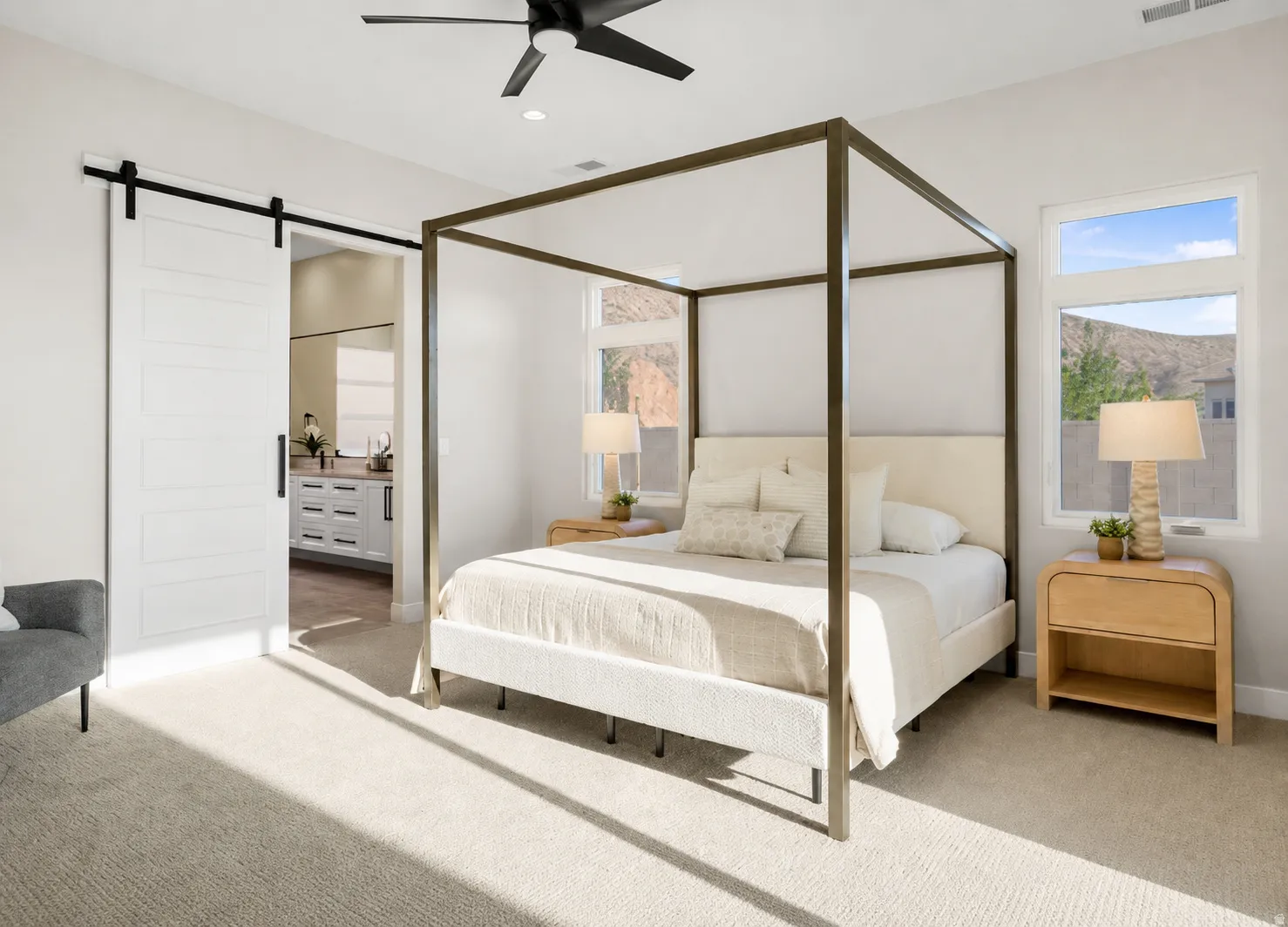 Spacious room featuring light-colored carpeting and a modern black ceiling fan
