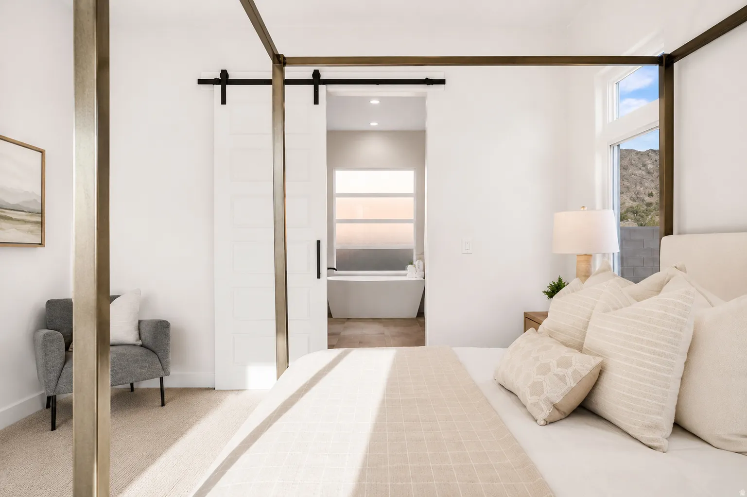 White barn door entry to a bathroom featuring a freestanding tub