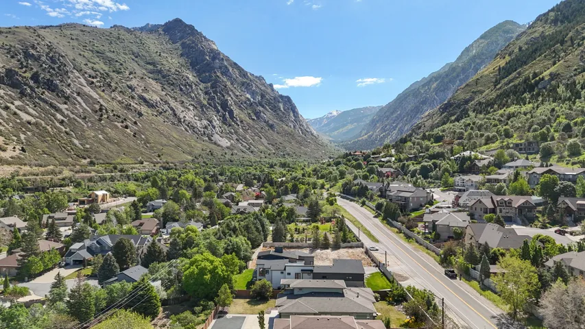 Aerial perspective showcasing a residential community nestled within a mountainous valley