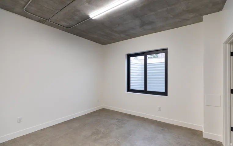 Concrete flooring with a contrasting white wall finish
