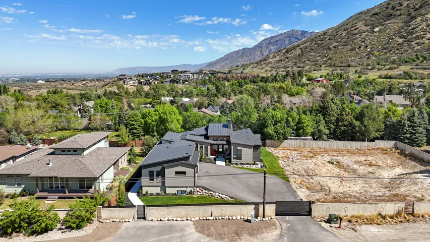 Modern architectural residence featuring a multi-level roofline and a combination of grey and white exterior finishes