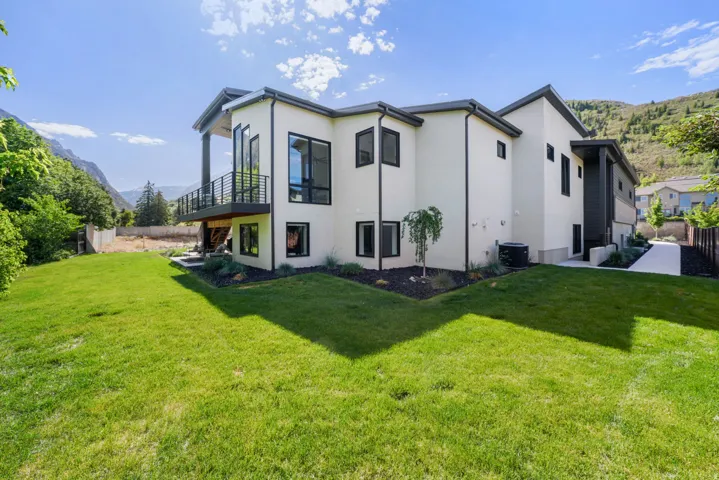 Modern architecture featuring a light-colored exterior with black-framed windows