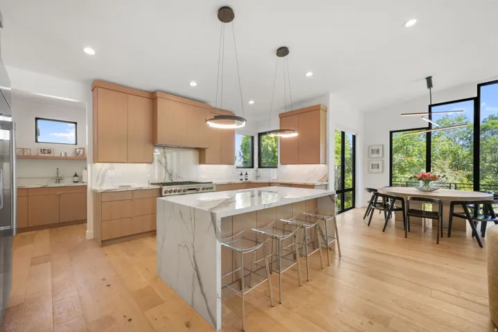 Open-concept kitchen and dining area featuring light wood-finish flooring