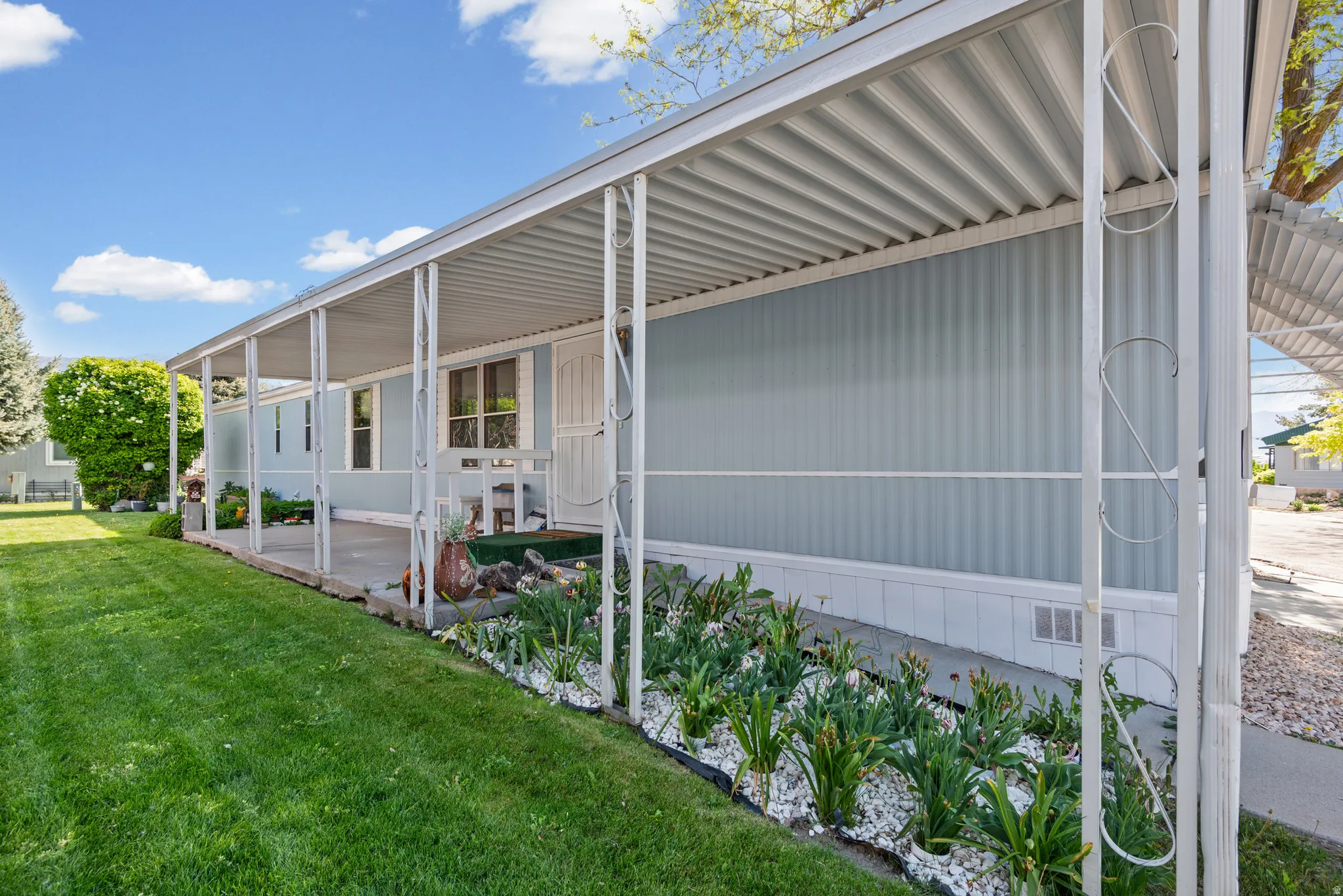 Covered patio featuring a corrugated metal roof and white support columns
