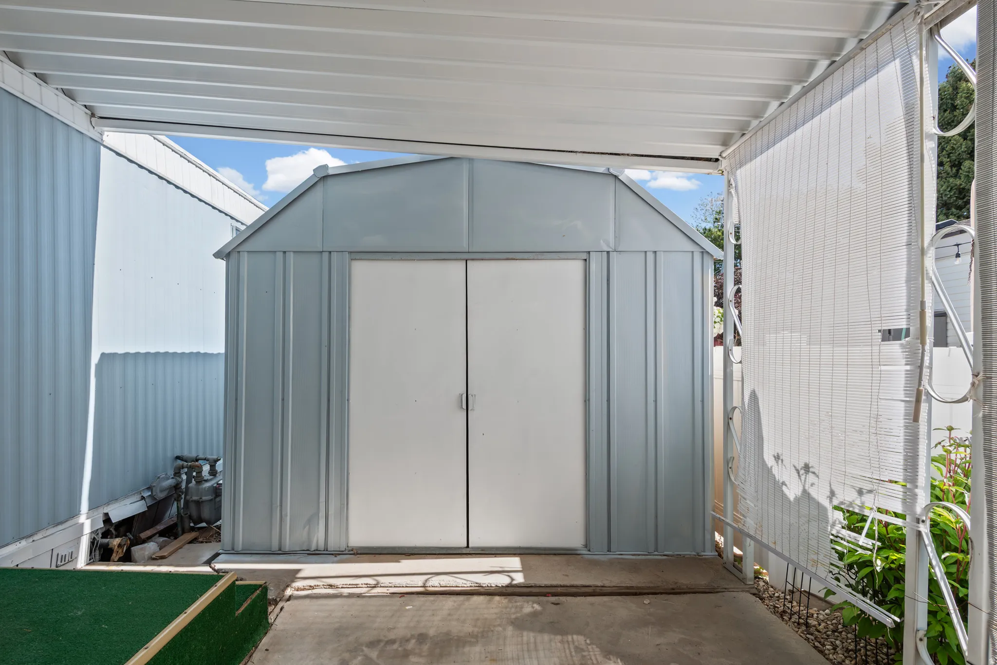 Metal storage shed with double white doors