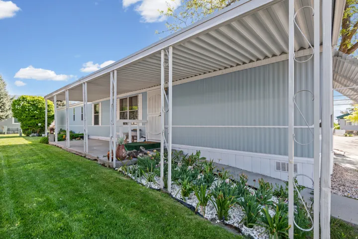 Covered patio featuring a corrugated metal roof and white support columns