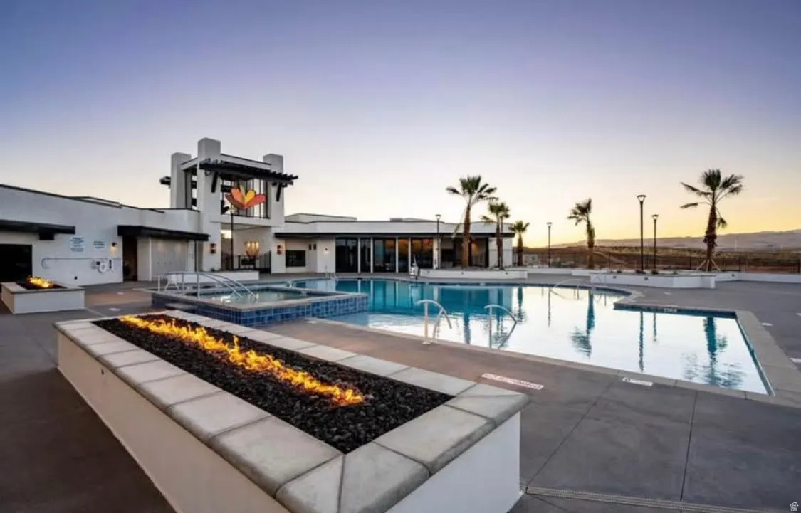 Outdoor amenity area featuring multiple pools, integrated spas, and a prominent fire pit