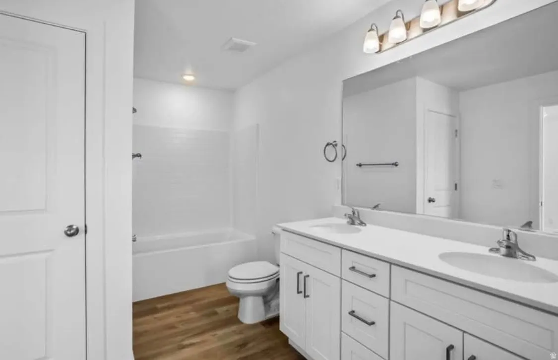 Double vanity with white cabinetry, integrated sinks, and chrome faucets