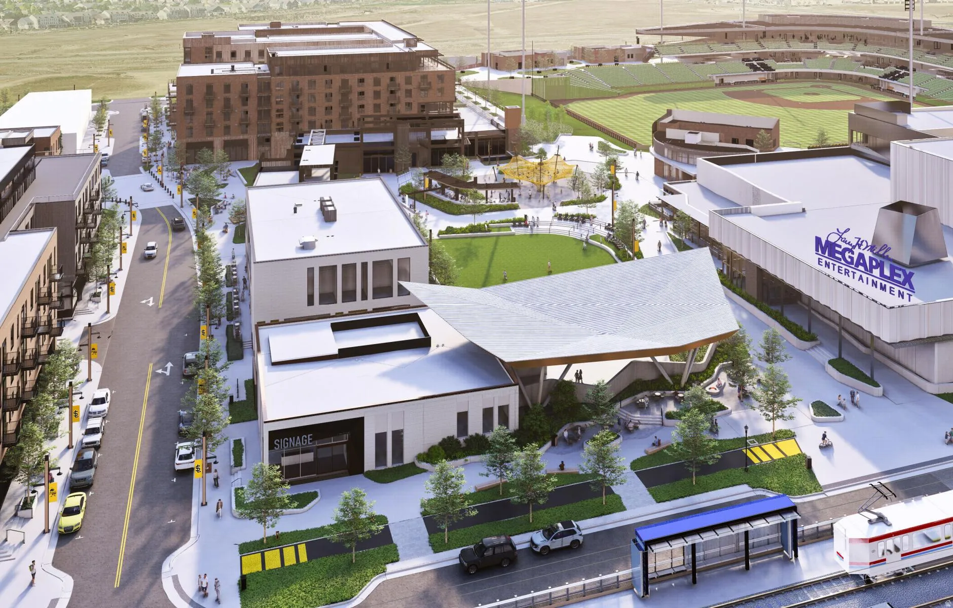 Urban development featuring a multi-story building, an entertainment complex, a public park with green spaces, a baseball stadium, and a street with a train station
