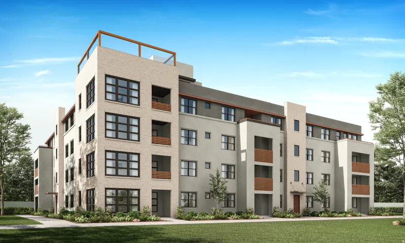 Contemporary multi-story building featuring light-toned brick and stucco exteriors