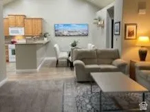 Open-concept living space with a vaulted ceiling and recessed lighting