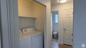 Dedicated laundry area with included washer and dryer, featuring a convenient overhead shelf