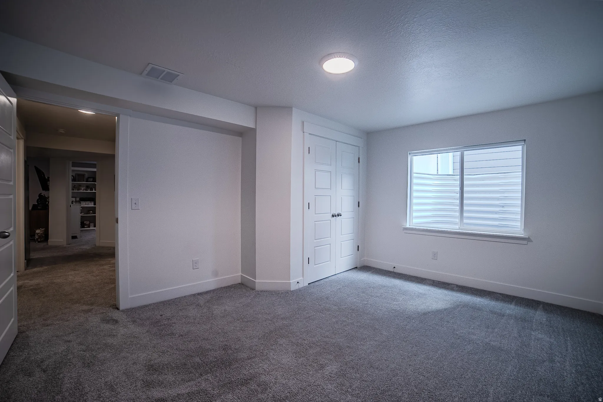Neutral carpeting with white baseboards