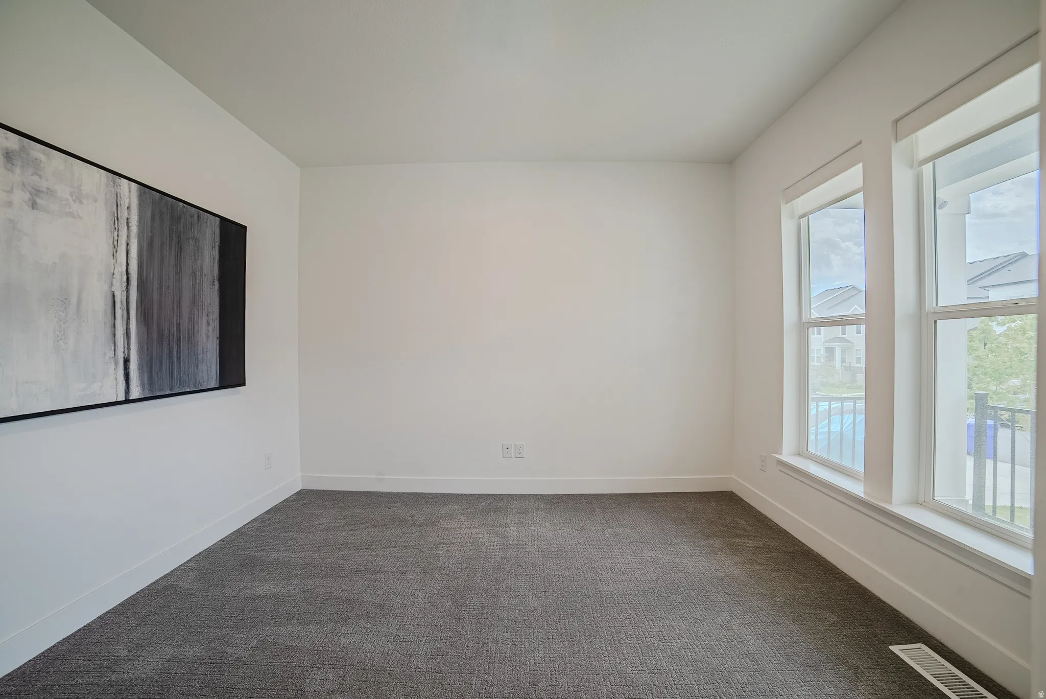 Neutral interior with gray carpet flooring and white walls