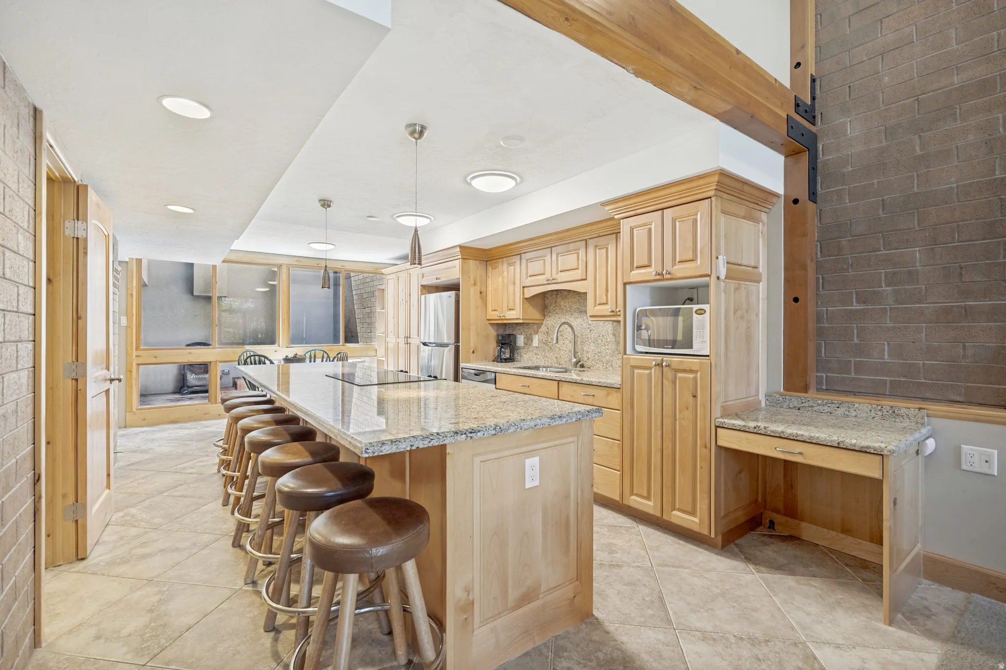 Spacious kitchen featuring an extended island and an additional desk/workspace