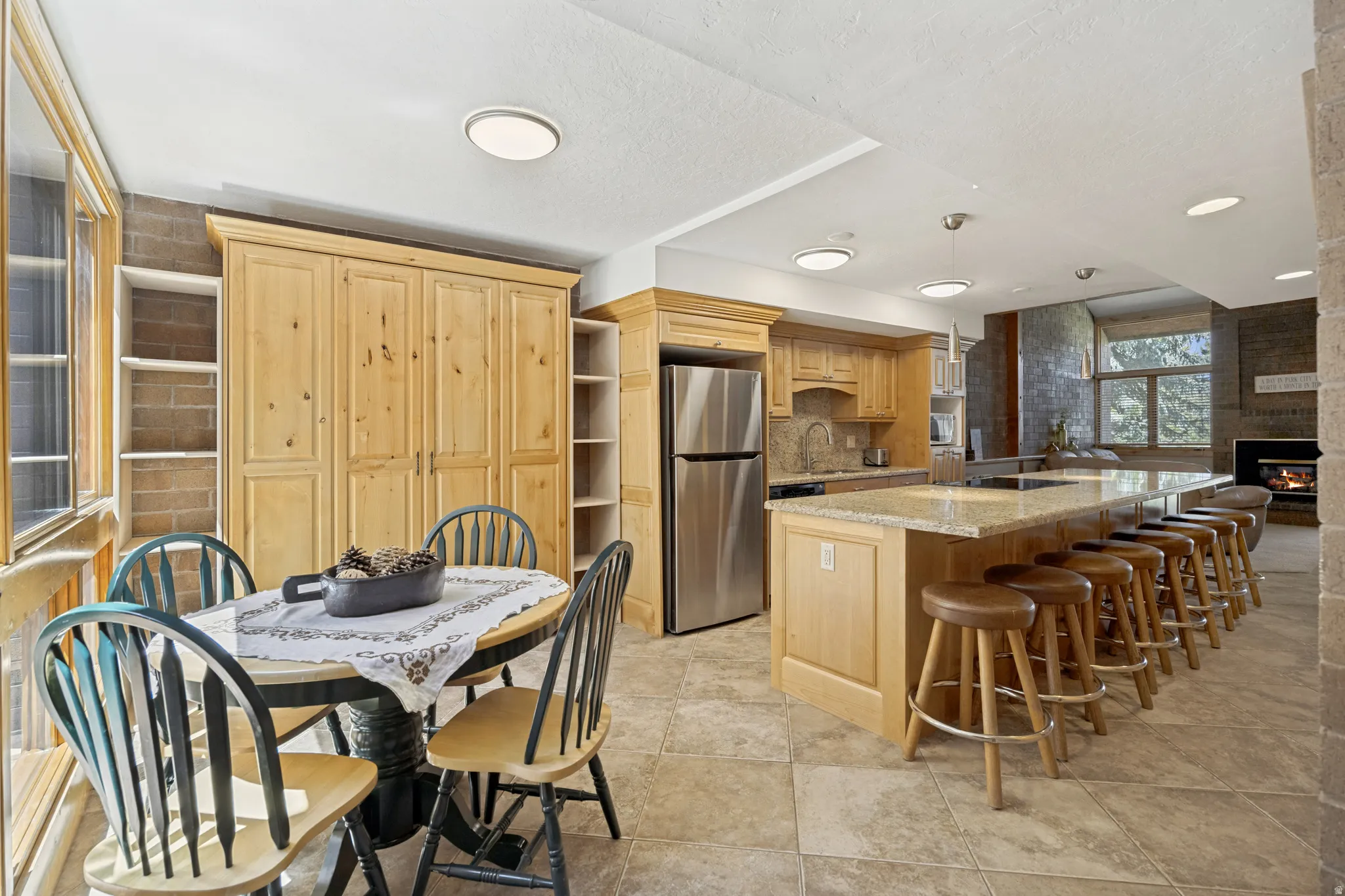 Kitchen featuring a large central island with seating. Cabinet behind dining table is a Murphy Bed!