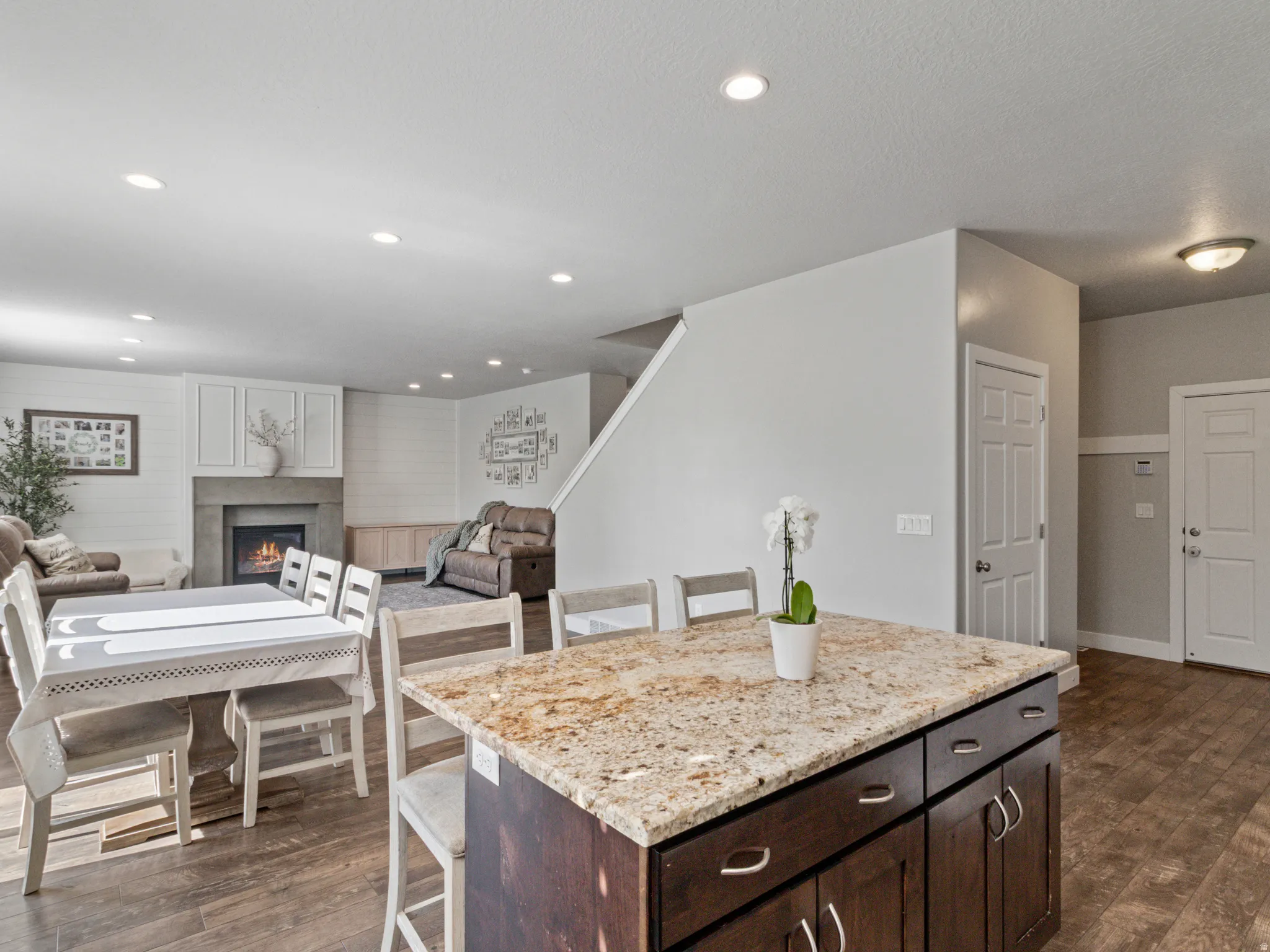 Kitchen island featuring a granite countertop and dark wood-finish cabinetry
