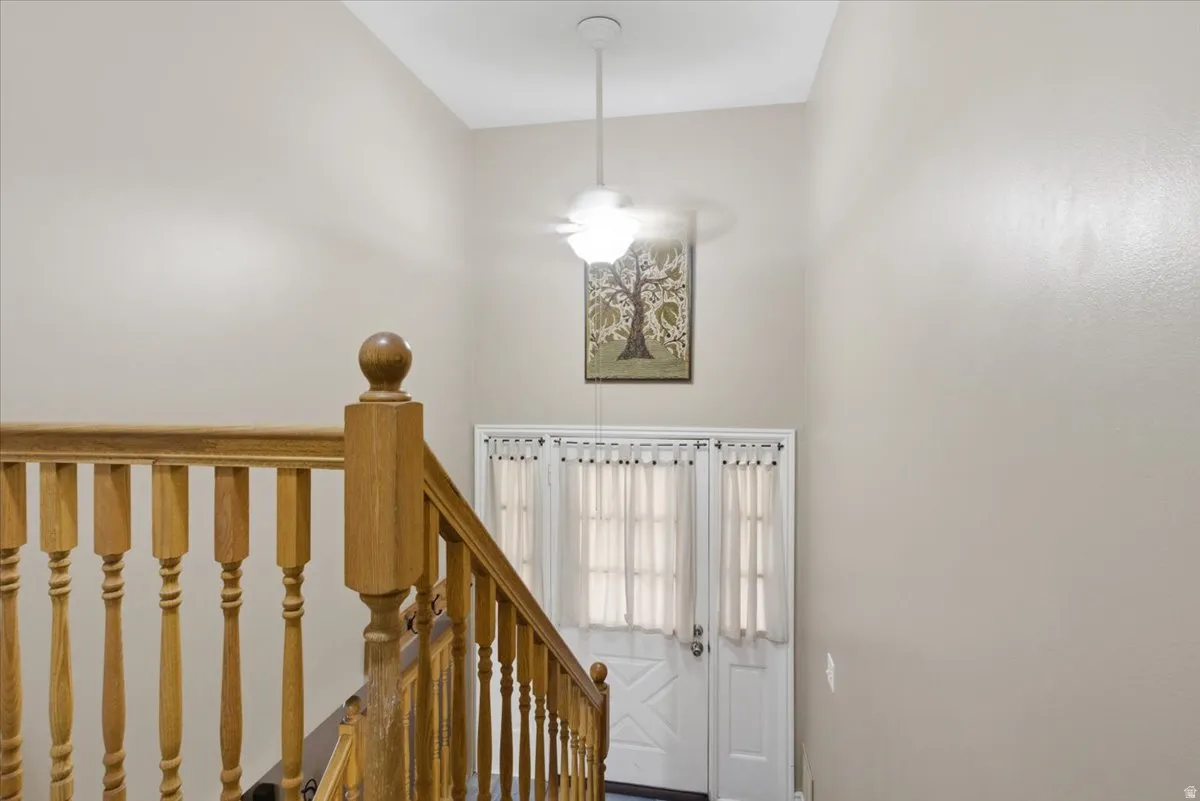 Staircase featuring wood balusters and newel post