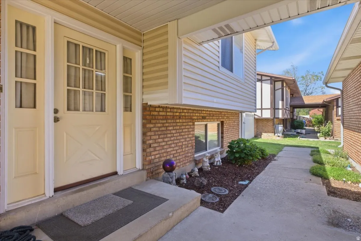 Entryway featuring a panel door with multiple windowpanes, flanked by two sidelight windows