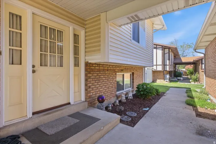 Entryway featuring a panel door with multiple windowpanes, flanked by two sidelight windows