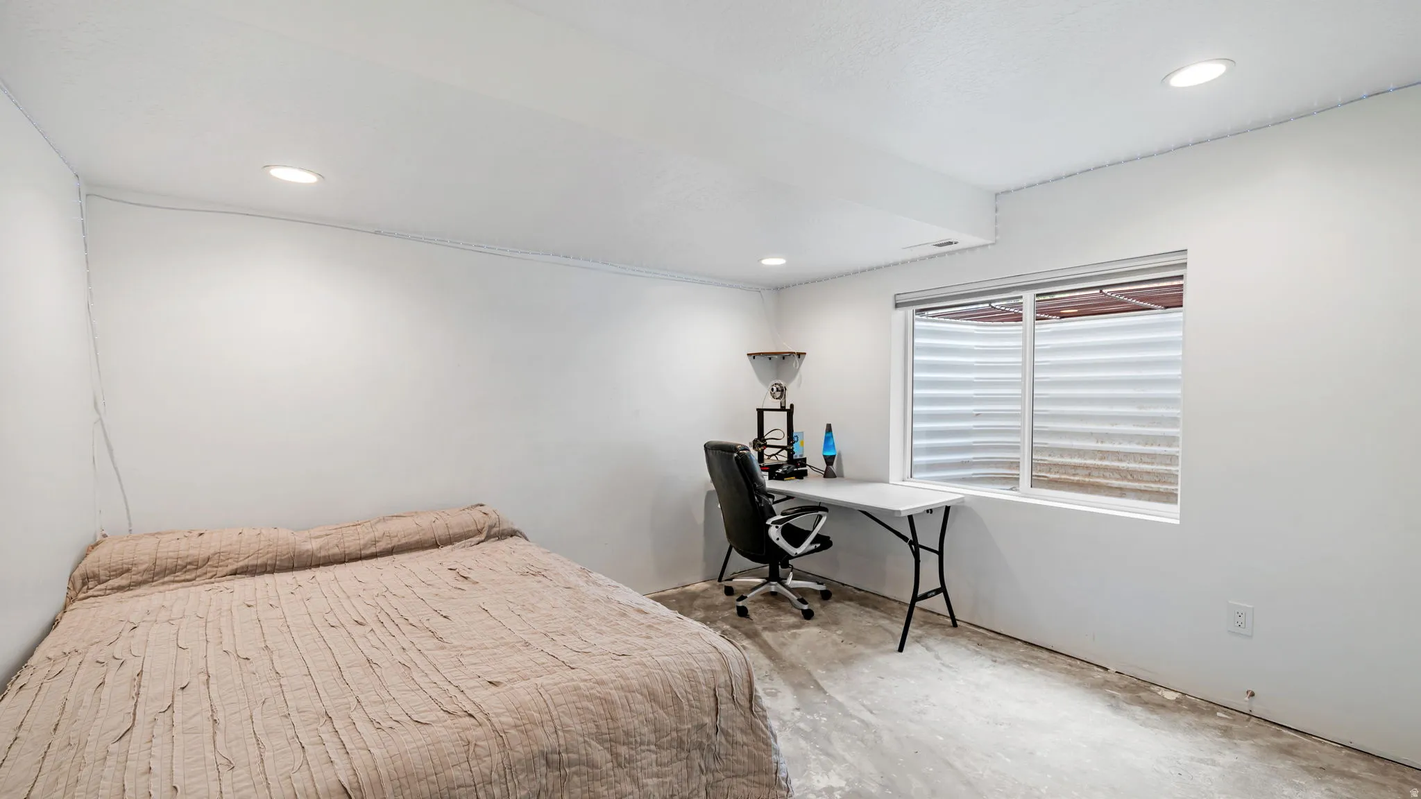 Room featuring white walls, recessed ceiling lighting, and a single window with a white frame