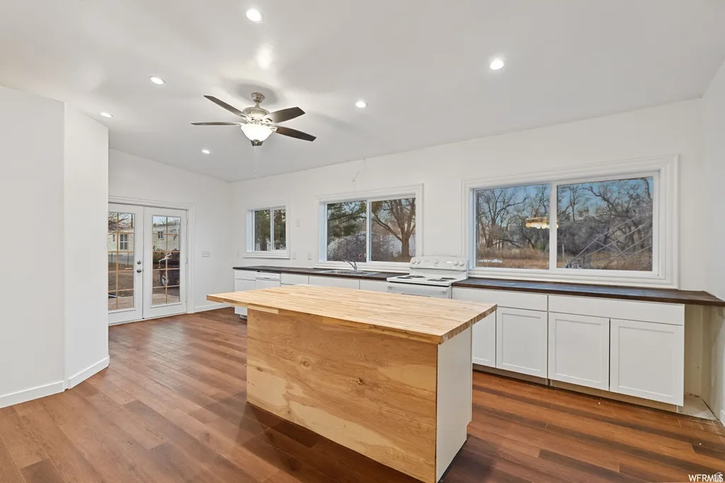 Kitchen with wood counters, a center island, french doors, recessed lighting, and ceiling fan