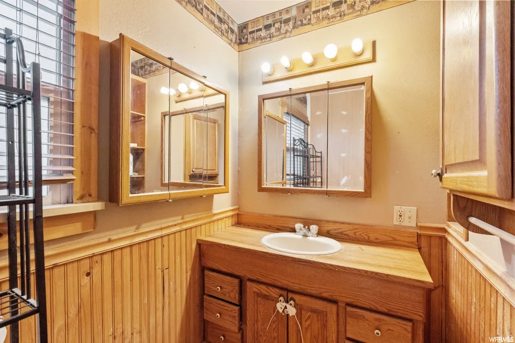 Bathroom with vanity and wainscoting