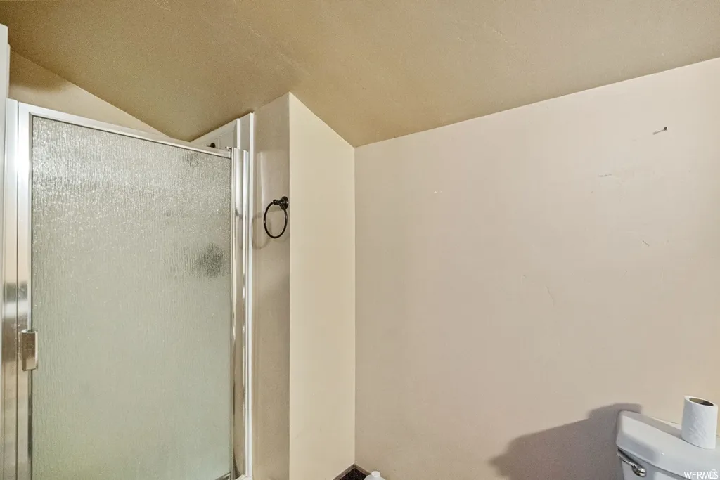 Bathroom with a stall shower and toilet