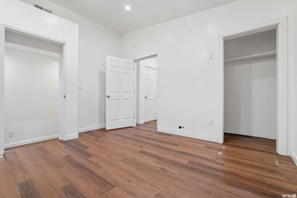 Unfurnished bedroom featuring dark wood finished floors and recessed lighting