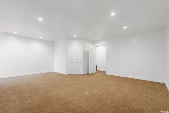 Basement featuring recessed lighting and carpet flooring