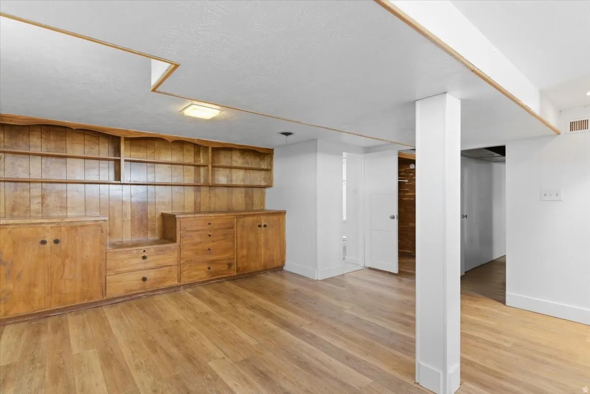 Expansive built-in shelving and cabinetry with a warm wood finish