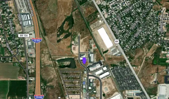 Strategic location map highlighting the property’s proximity to I-15, Highway 89, 2700 North, Rulon White Blvd, Parkland Blvd/1600 W, and nearby commercial/industrial growth.