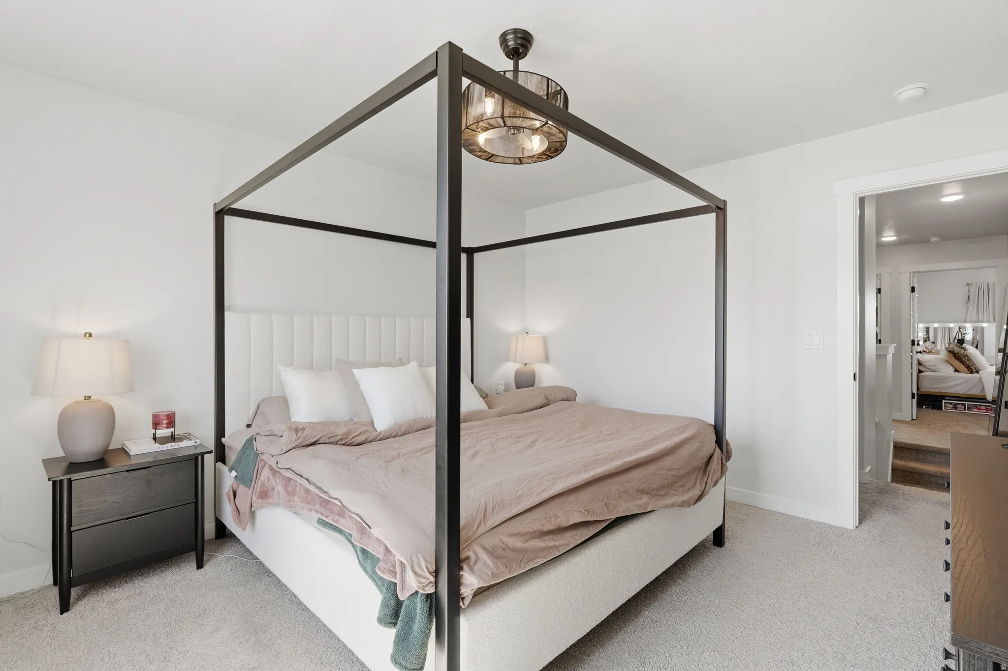 Carpeted bedroom featuring neutral wall paint, a built-in light fixture, and an open doorway
