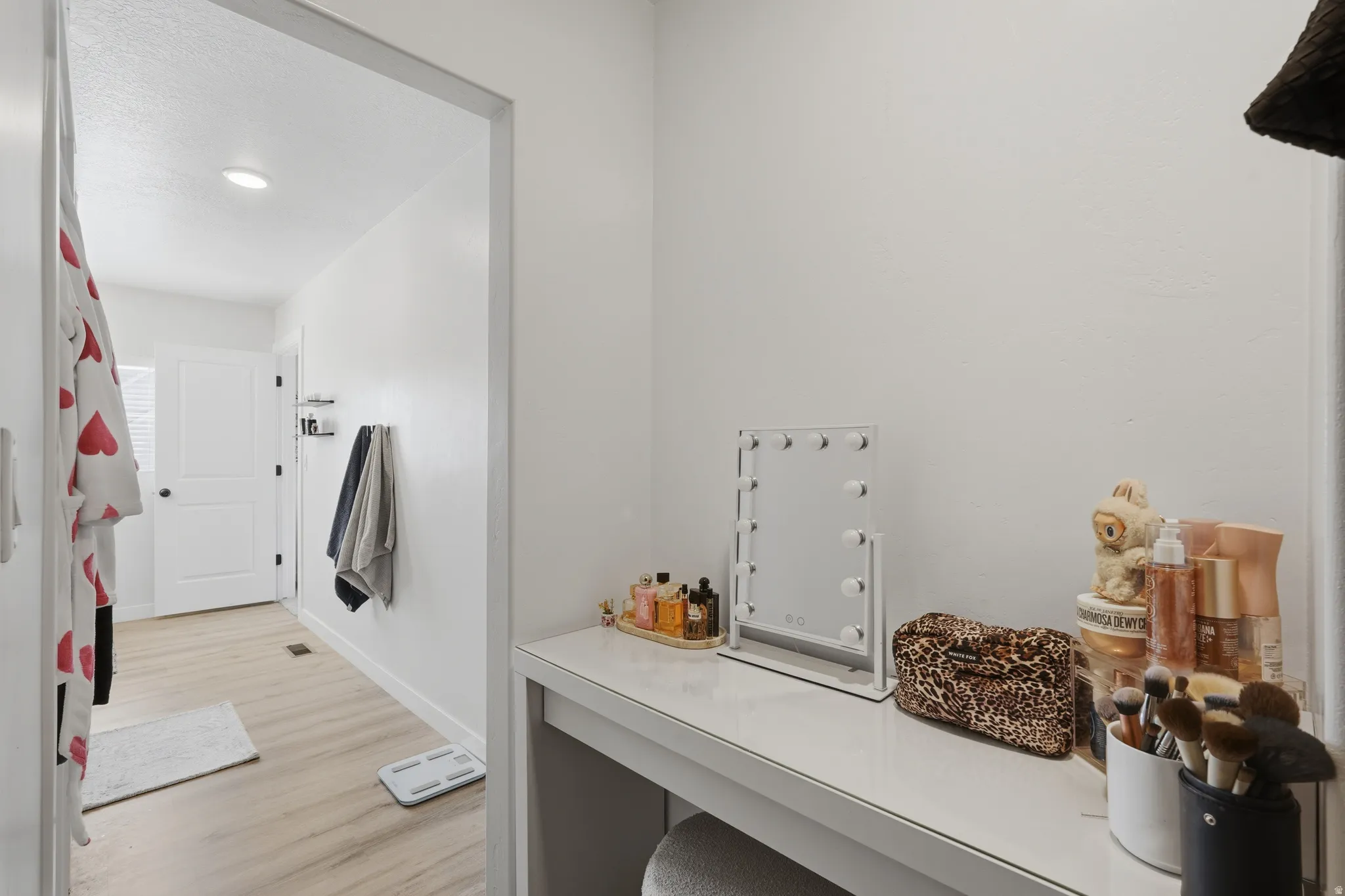 White wall vanity with a solid surface countertop