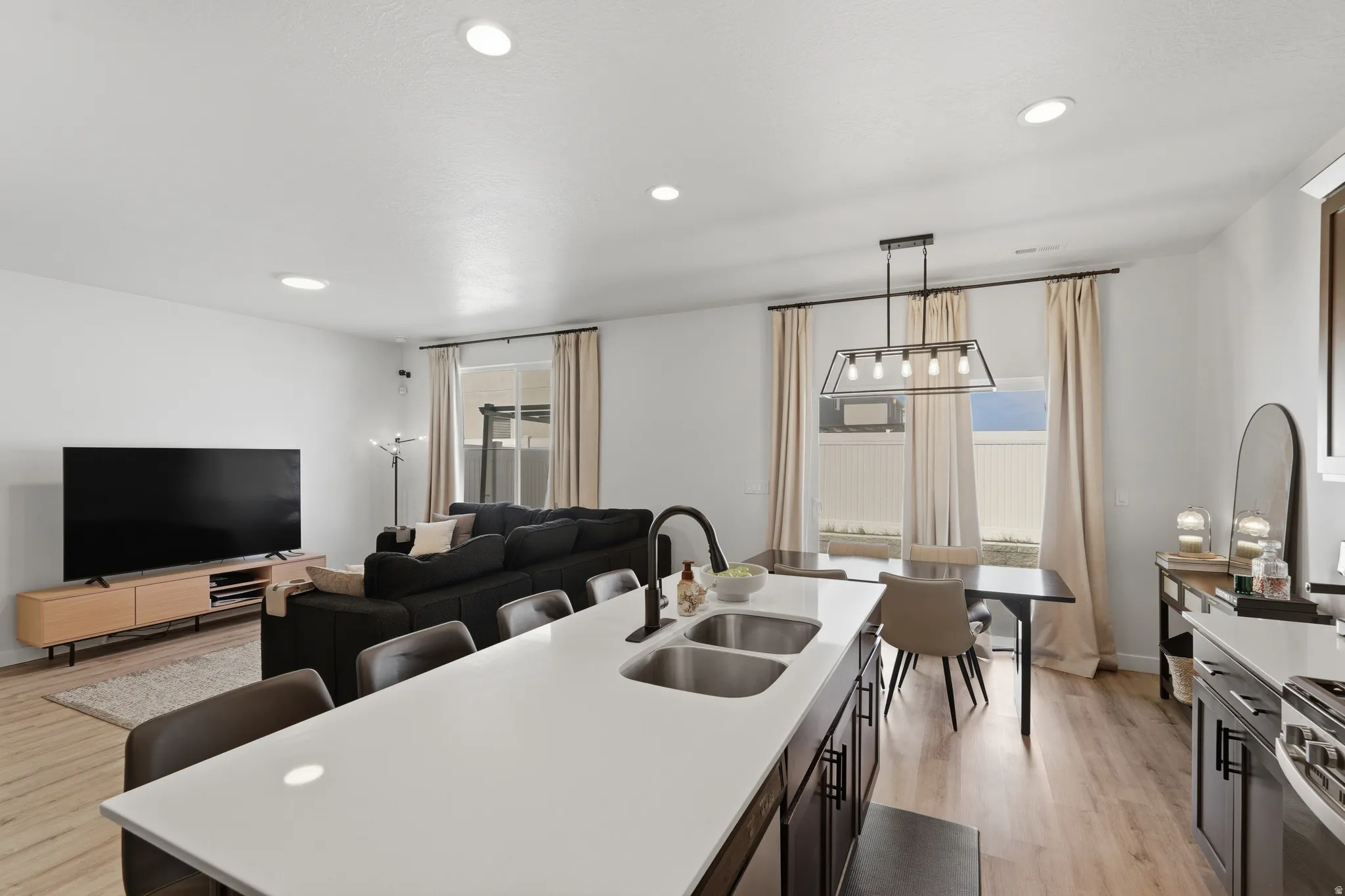 Open-concept living space with recessed lighting and light wood-finish flooring