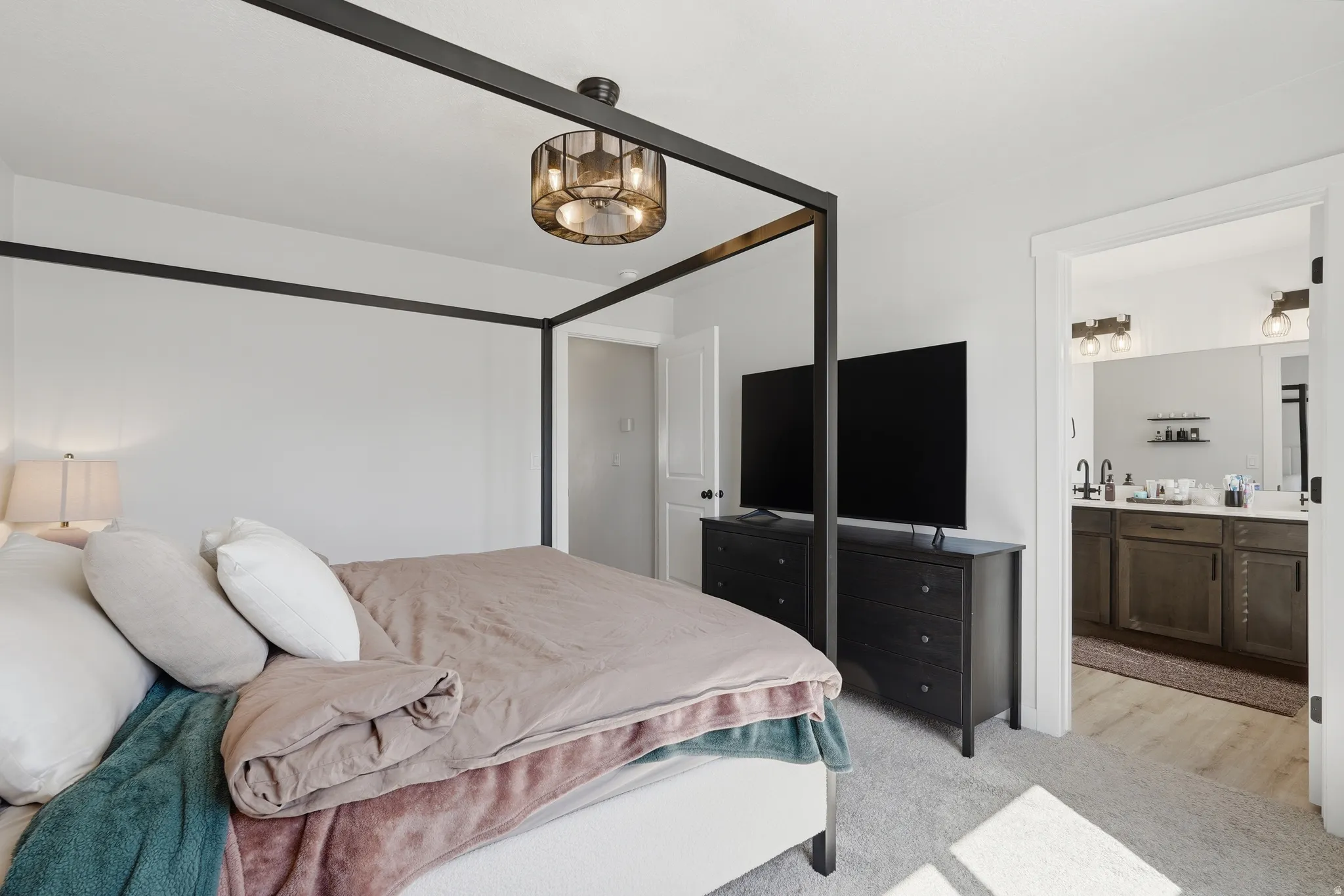 Carpeted room with a modern ceiling light fixture