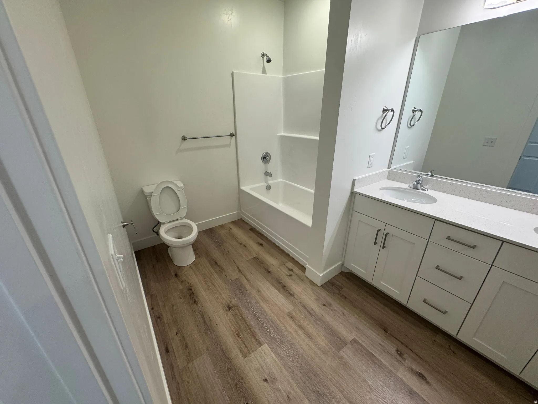 Bathroom featuring wood-finish flooring and a white vanity with a light-colored countertop