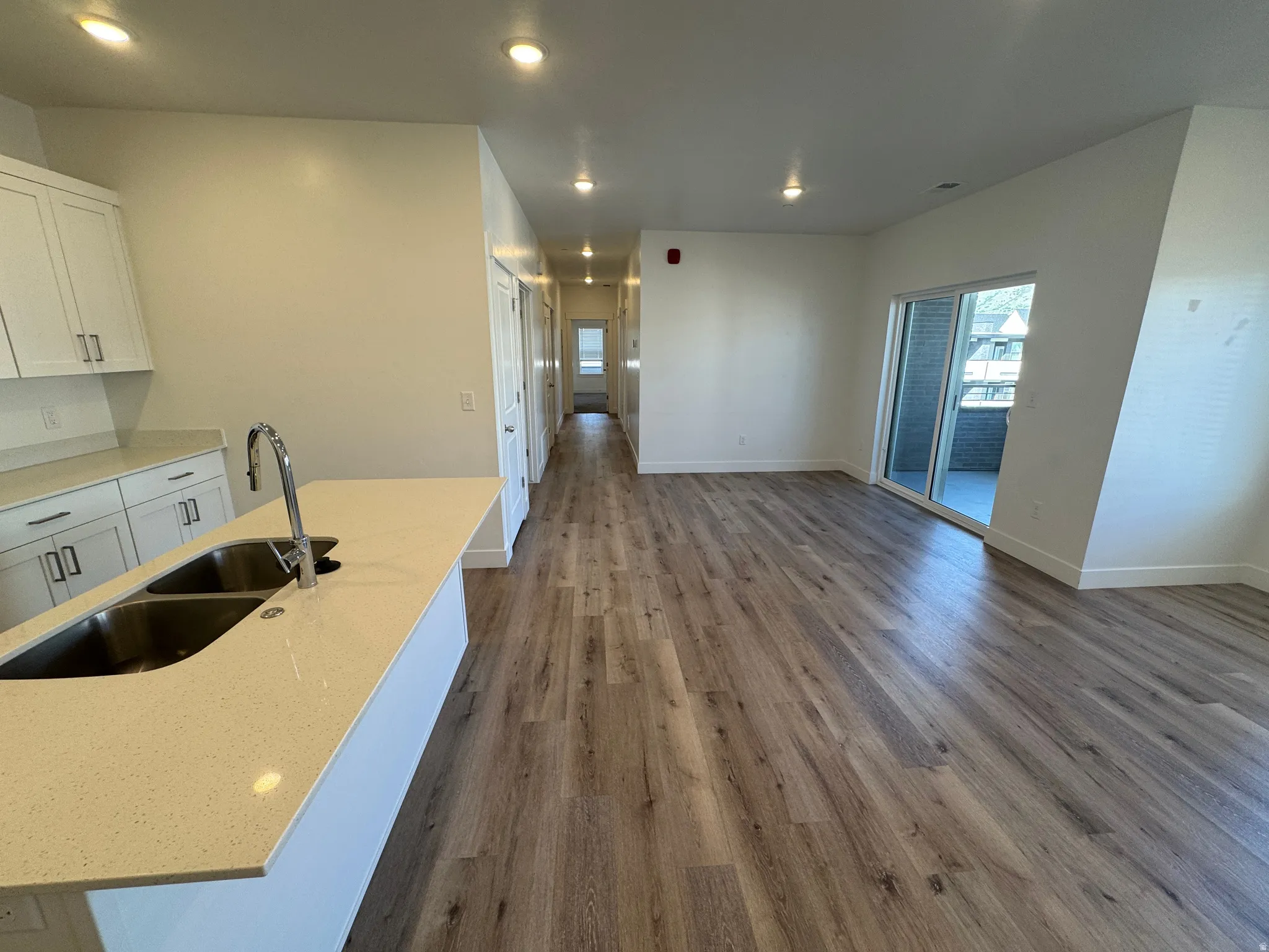 Open-concept living area with wood-finish flooring