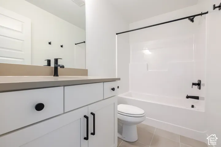 Vanity with white cabinetry and matte black hardware, integrated rectangular sink, matte black faucet, and large wall mirror