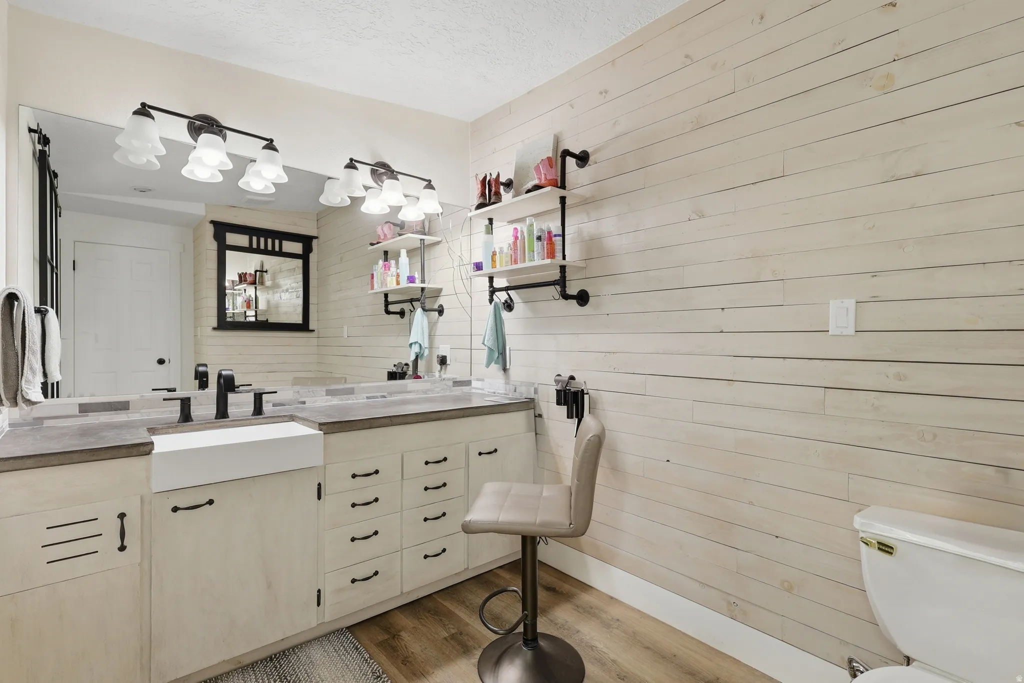 Double vanity with concrete-finish countertop, undermount sink, and matte black fixtures