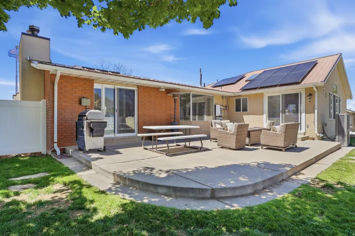 Expansive concrete patio with curved edges and a stucco and brick exterior