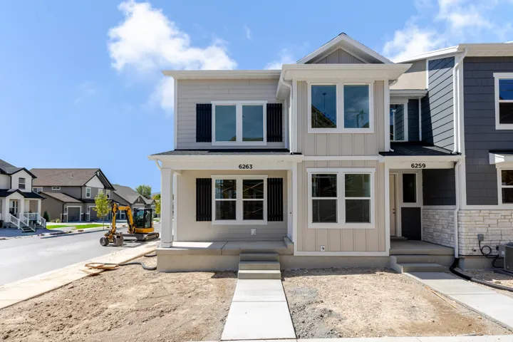 Contemporary exterior featuring light-colored siding and dark shutters