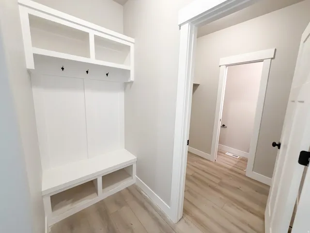 Built-in mudroom bench with cubby storage and overhead shelving