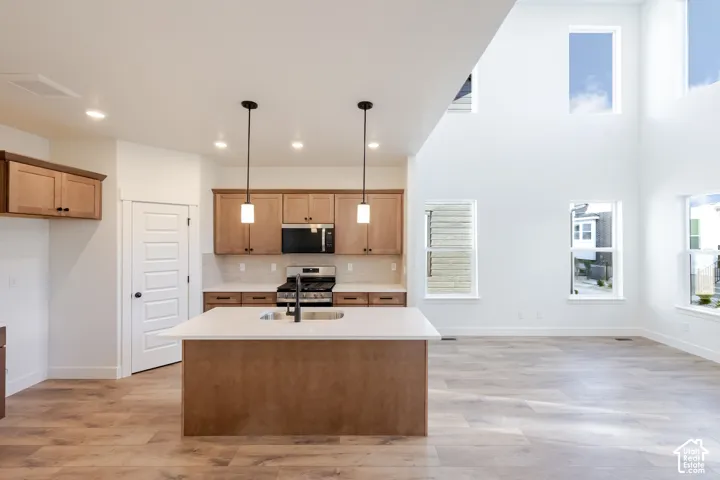 Kitchen island with a built-in sink and pendant lighting