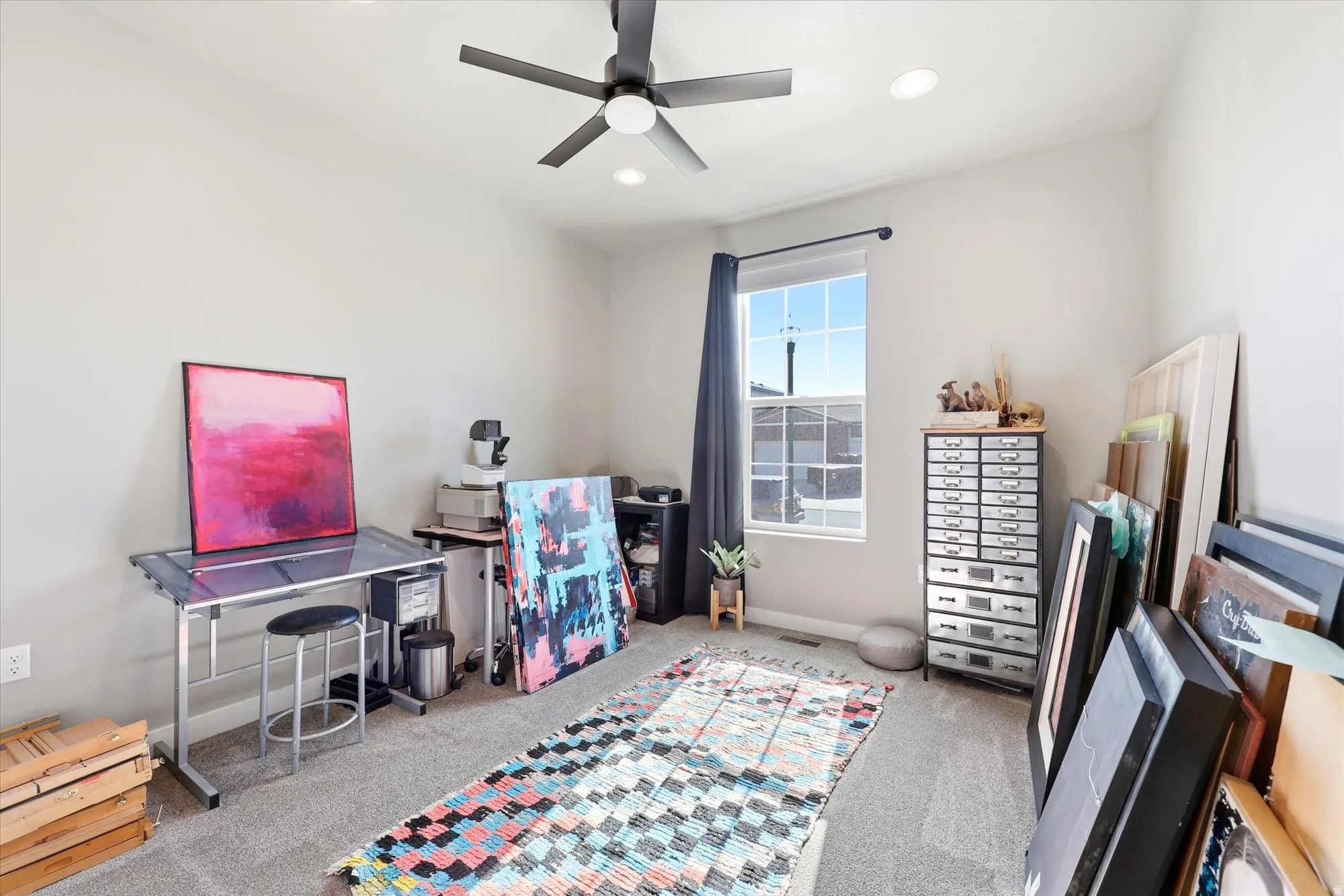 Spacious room featuring neutral carpeting and light gray walls
