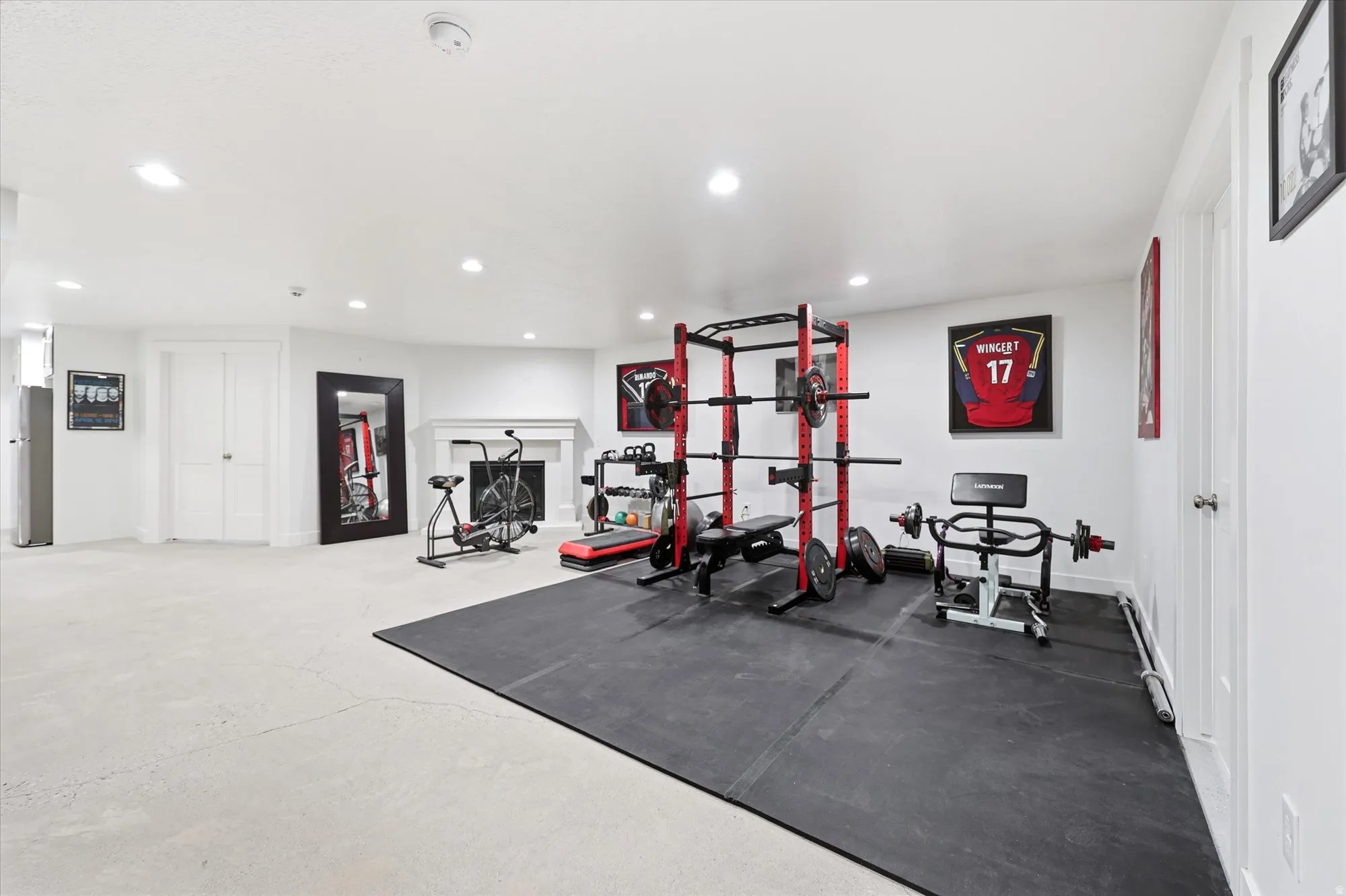 Spacious interior room with light-colored flooring and white walls