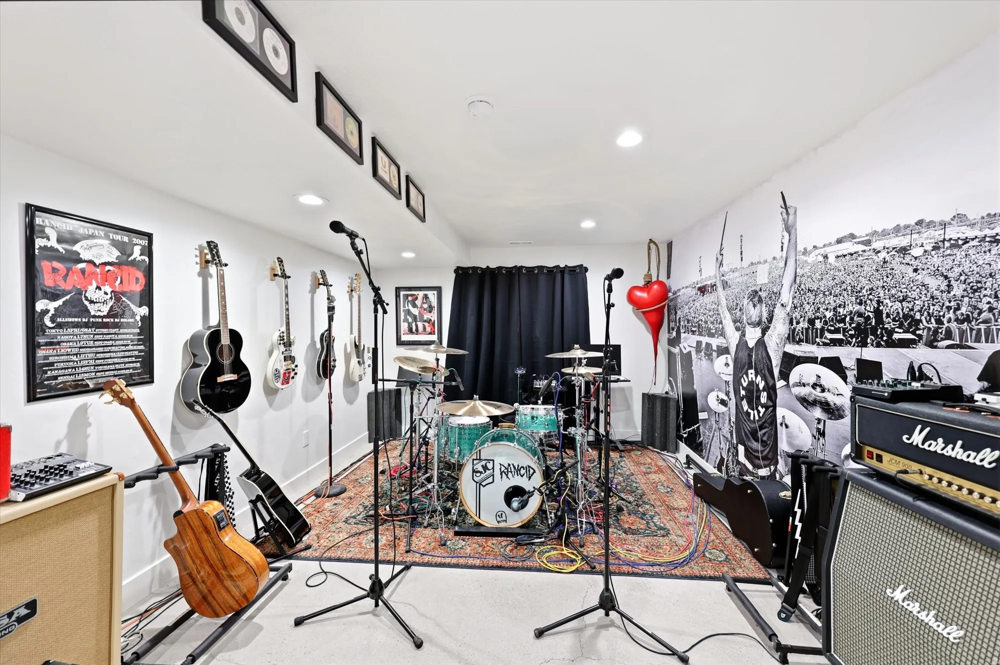 Versatile room featuring white walls, recessed lighting, and a dark carpeted area