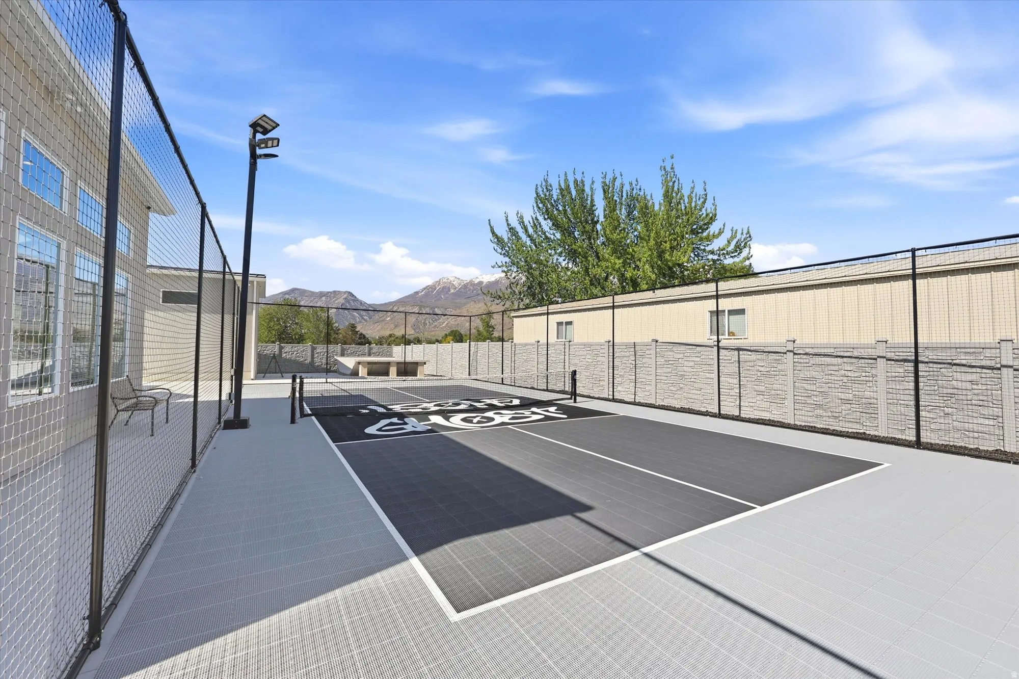 Outdoor sports court featuring a black and gray playing surface